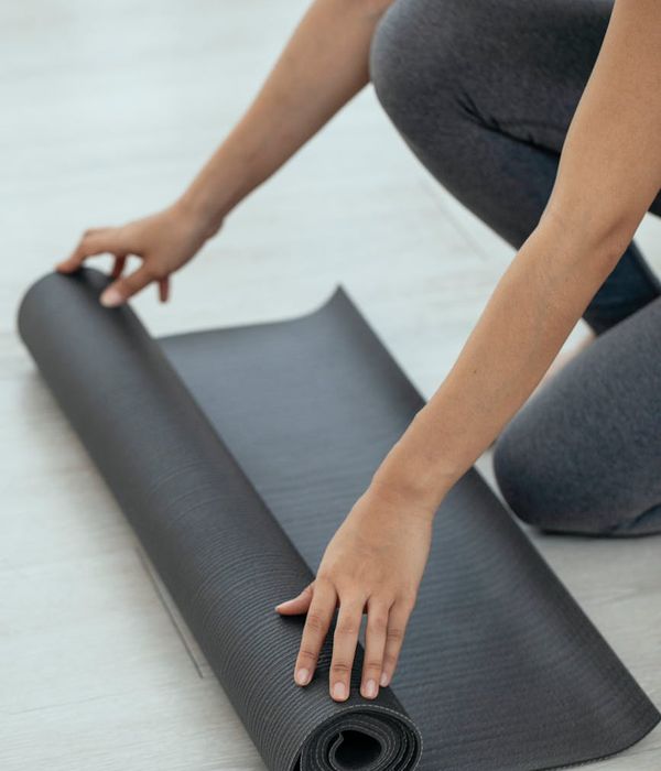 A calm and spacious room with yoga mats ready for practice.