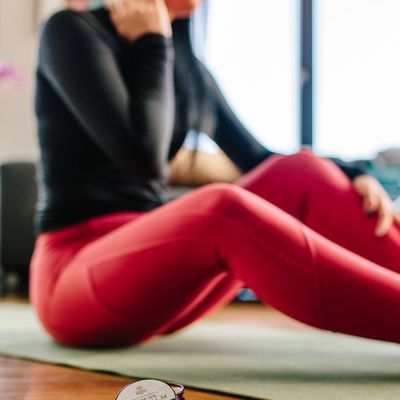 An empty yoga mat on a wooden floor.